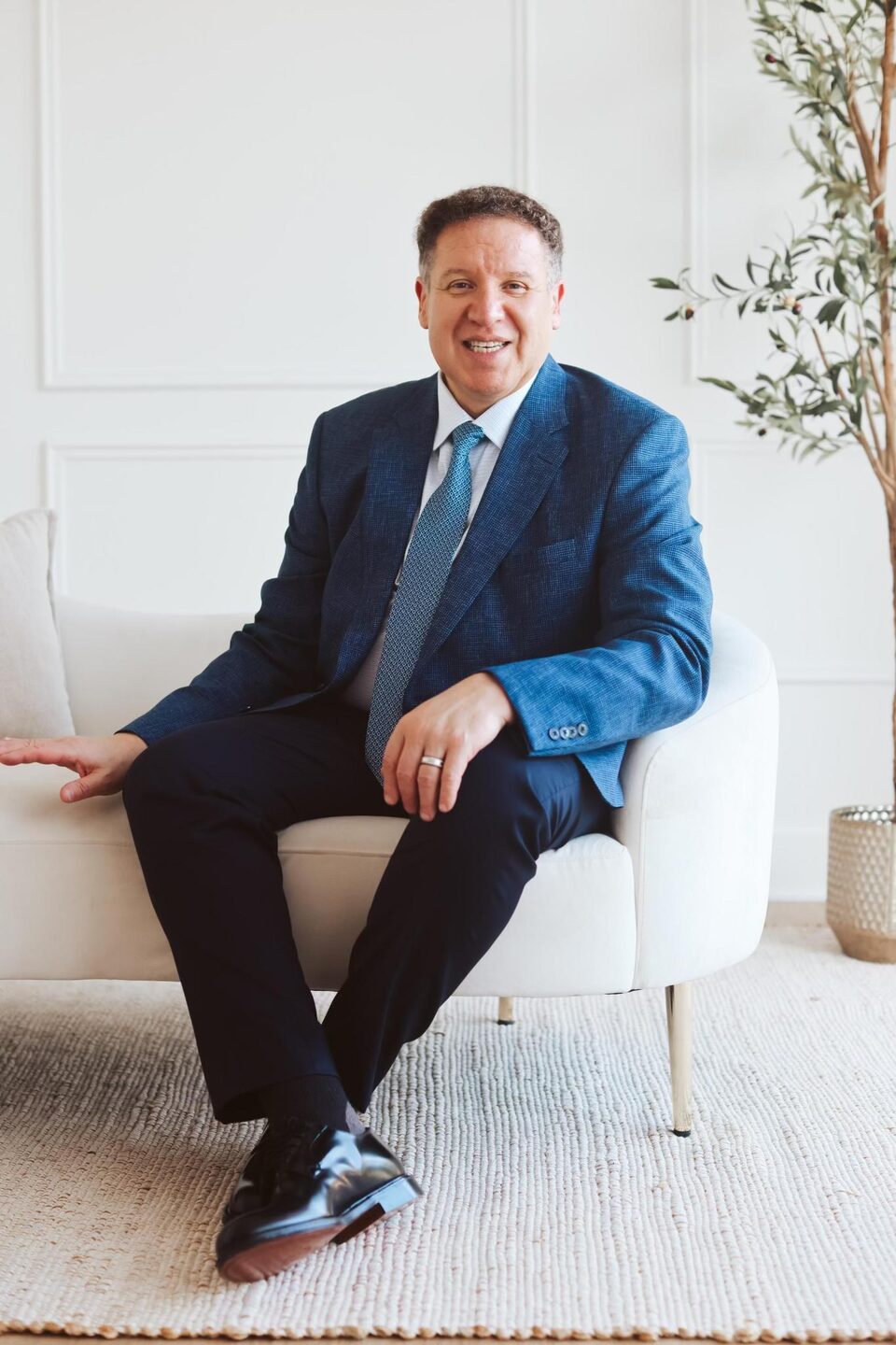 Attorney Carlos Maury, a former U.S. Immigration Judge, in a blue suit and tie.
